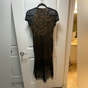 Black lace dress, nude lining, uneven hem. Size says M but fits more like a S